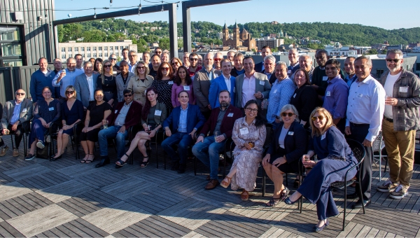 Group photo from Executive Advantage alumni symposium gathered outdoors at a networking event.