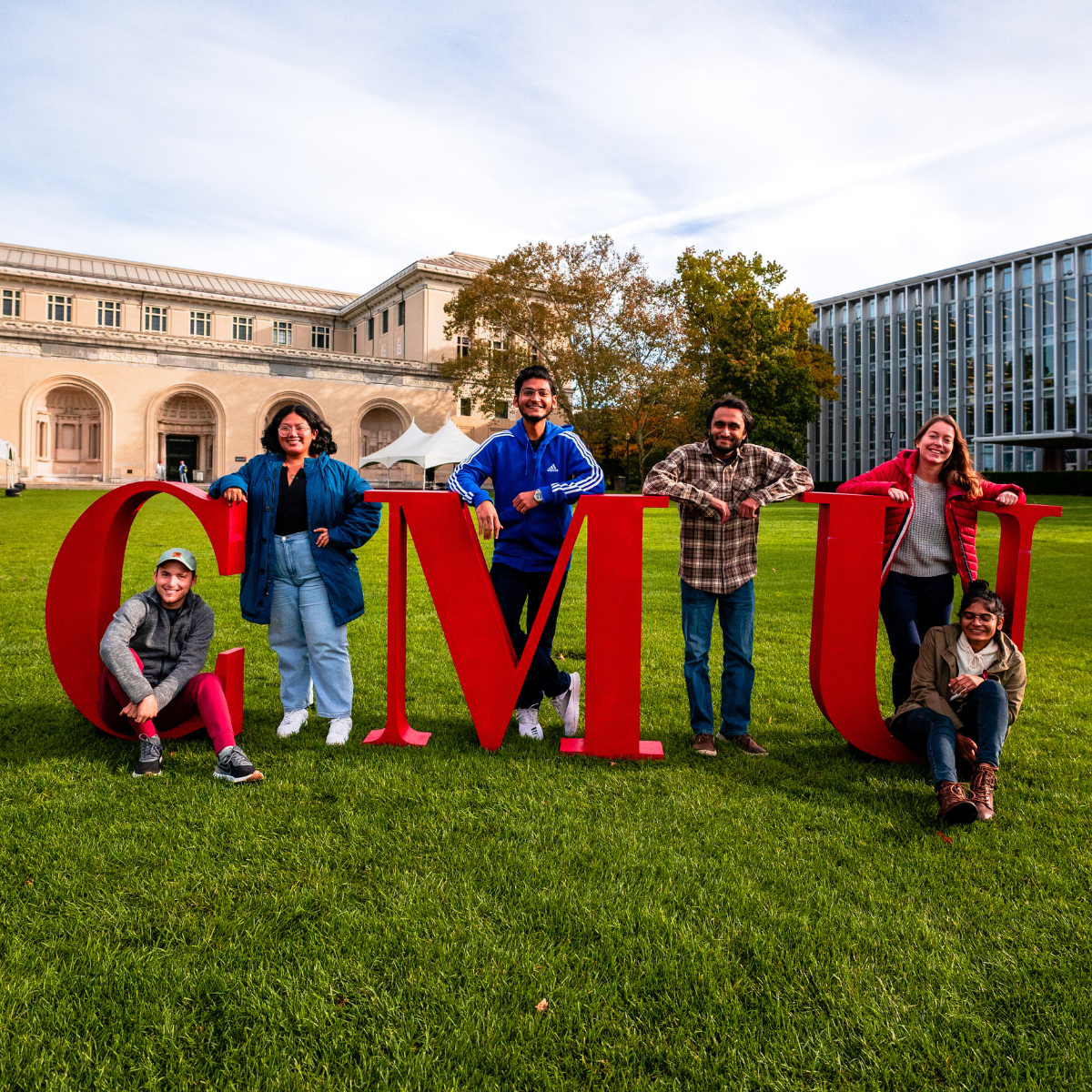 CMU students standing in life-size red CMU letters 