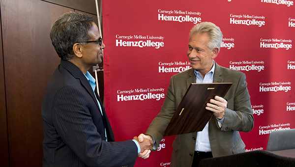 Krishnan is given a plaque during George D Smith Prize Ceremony